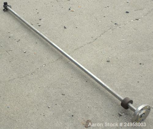 Used Agitator Shaft, 316 Stainless Steel. 1'' Diameter x 62-3/4'' long shaft with a 3'' diameter plastic impeller. 4-3/4'' O.D. (4) 1/2'' diameter hole mounting flange on approximate 2-5/8'' centers