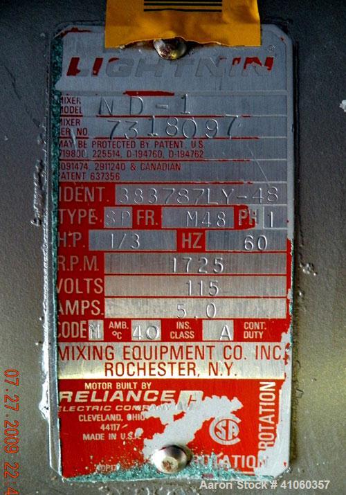 Used Lightnin Clamp-On Agitator, Model ND-1. 5/8" diameter x 50" long 304 stainless steel shaft with a 9" diameter 316 stainless steel 3 blade prop. Driven by a 1/3 hp, 1/60/115 volt, 1725 rpm motor.