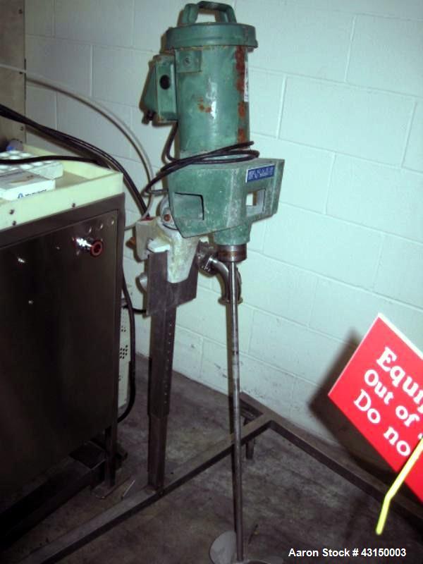 Used Lightnin Clamp Mount Agitator, Model XJ30VM. 32" Long stainless steel shaft, 9" propeller type blade, 1/3 HP 90 volt DC motor, with stand, serial# 9893B477C1.