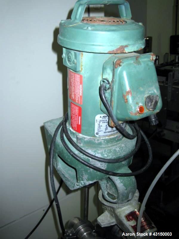 Used Lightnin Clamp Mount Agitator, Model XJ30VM. 32" Long stainless steel shaft, 9" propeller type blade, 1/3 HP 90 volt DC motor, with stand, serial# 9893B477C1.