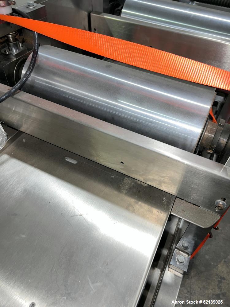 Used Shangha Target 11" Rolling & Scoring Line. Designed to make chiclets. Consisting of: Twin Screw extruder missing screws and die with motor drive, (3) sets of sheeting rollers measuring approxima...