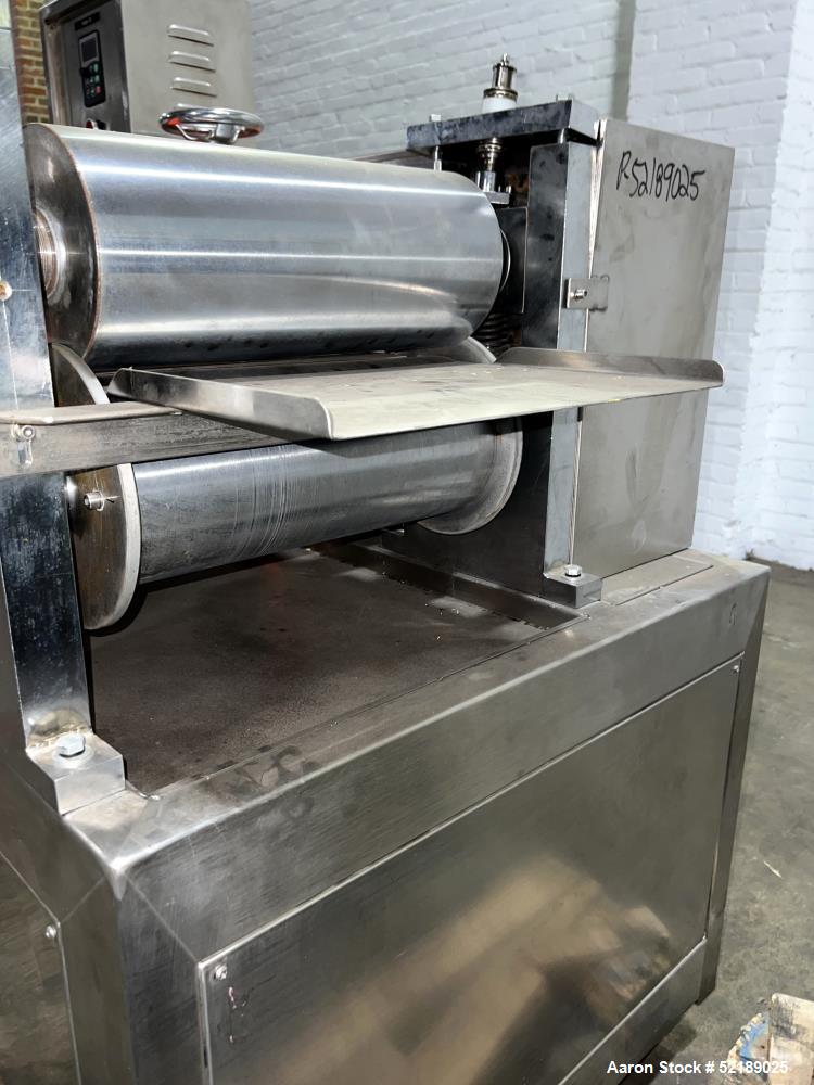 Used Shangha Target 11" Rolling & Scoring Line. Designed to make chiclets. Consisting of: Twin Screw extruder missing screws and die with motor drive, (3) sets of sheeting rollers measuring approxima...