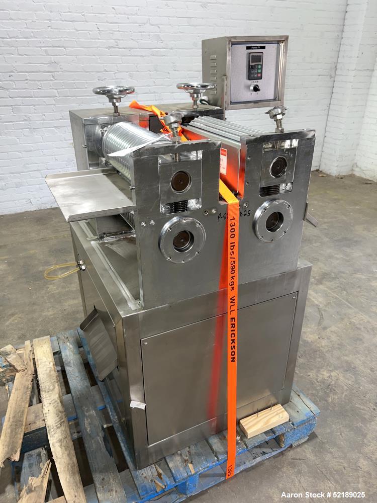 Used Shangha Target 11" Rolling & Scoring Line. Designed to make chiclets. Consisting of: Twin Screw extruder missing screws and die with motor drive, (3) sets of sheeting rollers measuring approxima...