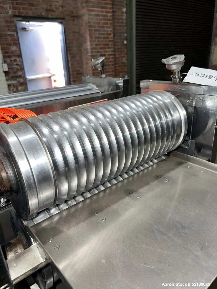Used Shangha Target 11" Rolling & Scoring Line. Designed to make chiclets. Consisting of: Twin Screw extruder missing screws and die with motor drive, (3) sets of sheeting rollers measuring approxima...