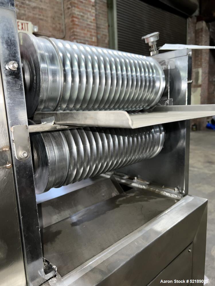 Used Shangha Target 11" Rolling & Scoring Line. Designed to make chiclets. Consisting of: Twin Screw extruder missing screws and die with motor drive, (3) sets of sheeting rollers measuring approxima...
