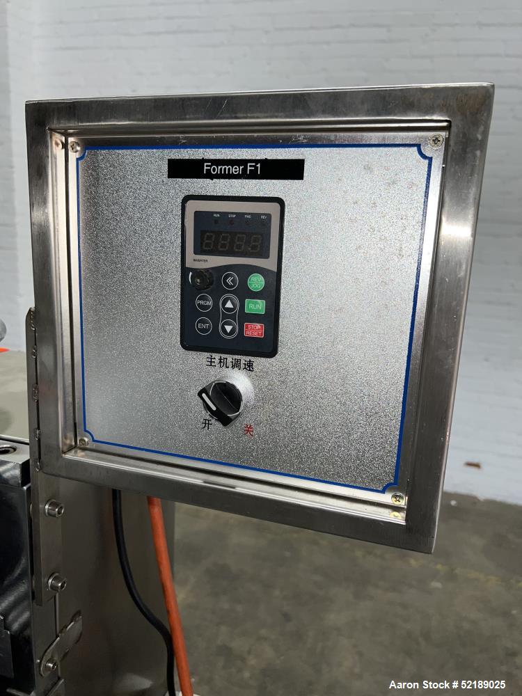 Used Shangha Target 11" Rolling & Scoring Line. Designed to make chiclets. Consisting of: Twin Screw extruder missing screws and die with motor drive, (3) sets of sheeting rollers measuring approxima...