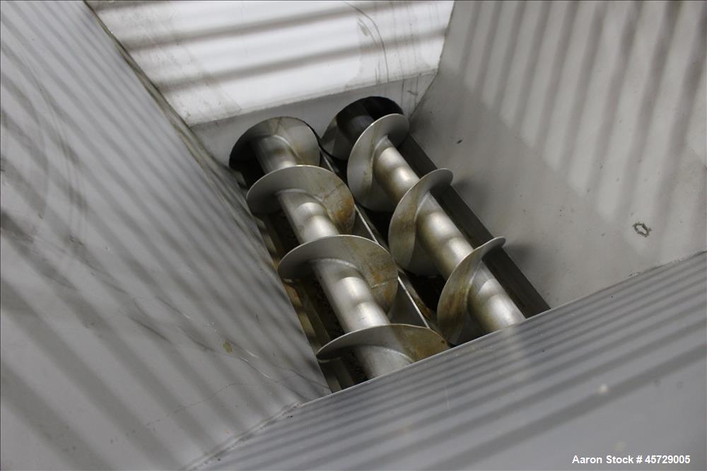 Used Mepaco Dual Auger Feeder, Model 105, 3,000 pound capacity, 304 Stainless Steel. Hopper is 60" long x 64" wide x 36" deep. Includes (2) 8" diameter x 48" long augers, driven by a 7.6kw, 3/60/230/...