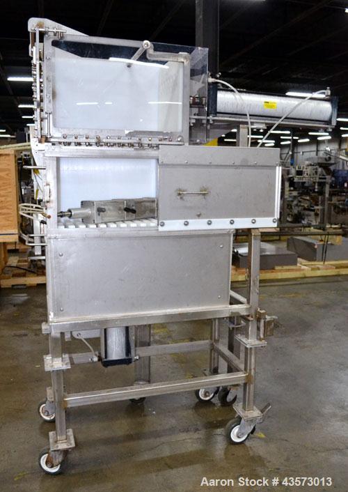 Used Cheese Block Cutter/Portioner. Machine is of stainless steel construction. Designed to cut blocks approximately (length) 17-1/2" x (Width) 14-1/4" x 24". Is an upcut into a cross cut direction m...
