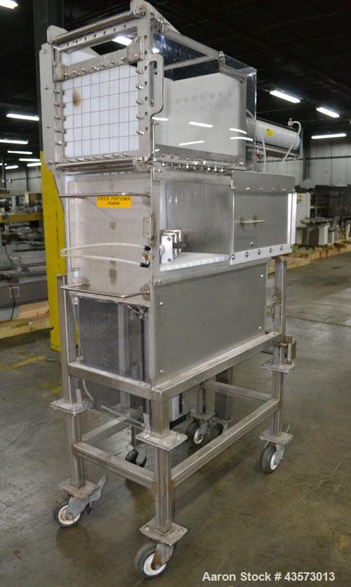 Used Cheese Block Cutter/Portioner. Machine is of stainless steel construction. Designed to cut blocks approximately (length) 17-1/2" x (Width) 14-1/4" x 24". Is an upcut into a cross cut direction m...