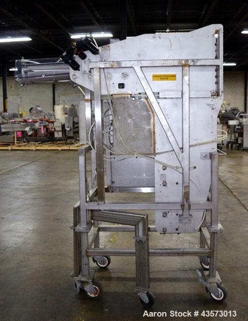 Used Cheese Block Cutter/Portioner. Machine is of stainless steel construction. Designed to cut blocks approximately (length) 17-1/2" x (Width) 14-1/4" x 24". Is an upcut into a cross cut direction m...