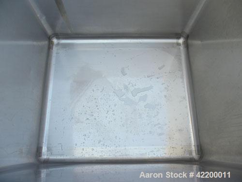 Used Custom Powder Systems Open Top Rolled Lip Bin, 49.4 cubic feet, 304L stainless steel. 42’’ wide x 48’’ long x 48’’ deep. Mounted on stainless steel legs.
