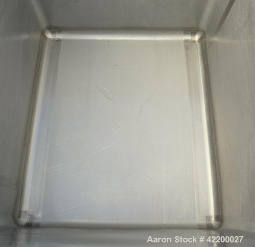 Used Custom Powder Systems Open Top Rolled Lip Bin, 49.4 cubic feet, 304L stainless steel. 42’’ wide x 48’’ long x 48’’ deep. Mounted on stainless steel legs.