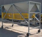 Used Front End Loading Hopper/Feeder, approximate 10 ton storage capacity, approximate 150 cubic feet, carbon steel. Coned top hopper 160'' long x 62'' wide x 56'' deep. Bottom discharge rubber belt,...