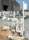 USED: Stokes heating skid, model 600-540. Designed for water heating for a conical or shelf dryer. Consists of (1) heat exchanger, shell and tubes rted for 125 psi at 400 deg F; (1) 3/4 hp XP pump, m...