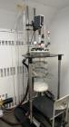 Used AG! Glassplant 20L Pilot Plant Nutsche Filter. 20 Liter Capacity. Filtration area 514.7 cm2. Glass vessel. Top entering overhead stirrer. Mounted on frame with casters.