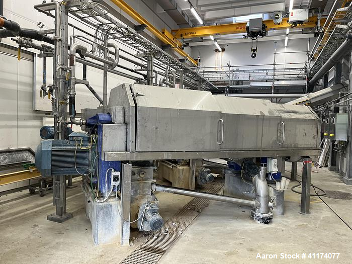 Used Alfa Laval DSNX 4850 Decanter Centrifuge. Stainless steel (product contact areas). Max bowl speed 3650 rpm, 2 phase separation (liquid/solids) design. Bowl dia: 480/263 mm (18.7/10.2), Bowl beach angle: 10°, 250 mm (10") pitch, conveyor flights are protected with around 200 tungsten carbide tiles, single row of 360 deg lined cake solids discharge ports, base, casing, gearbox 6 kNm, back drive 1:169 and Alfa Laval control panel with ABC controller. Previously used in a Medical WWT applicati