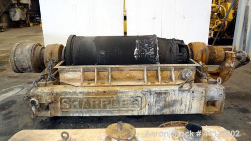 Used Sharples P-5000 Super-D-Canter Centrifuge. 316 Stainless steel product contact areas. Maximum bowl speed 3000 rpm. 5" Pitch conveyor, base, casing, cover, and feed pipe.