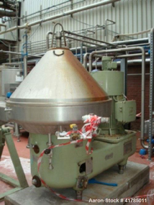Used Westfalia SA 100-33-777 Desludger Centrifuge, stainless steel, with self-cleaning disc and a 60 hp/45 kW belt drive at approximately 4000 rpm. Size 6.6' x 6.6' x 6.2' (2000 mm x 2000 mm x 1900 m...