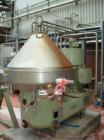 Used Westfalia SA 100-33-777 Desludger Centrifuge, stainless steel, with self-cleaning disc and a 60 hp/45 kW belt drive at approximately 4000 rpm. Size 6.6' x 6.6' x 6.2' (2000 mm x 2000 mm x 1900 m...