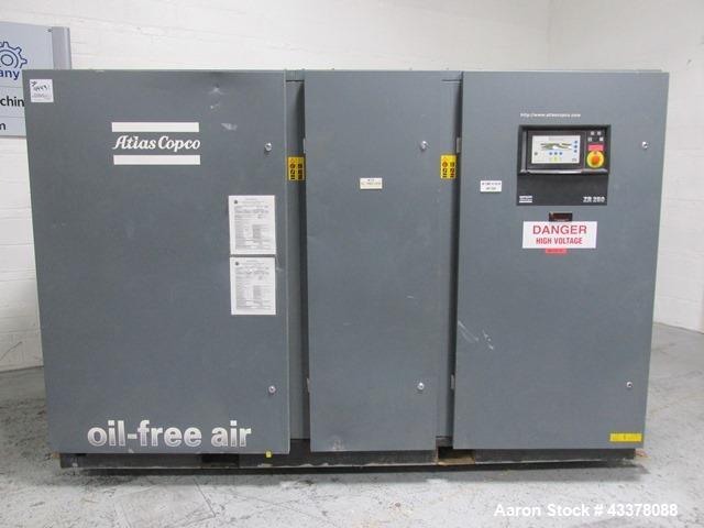 Used Atlas Copco Water Cooled Oil Free Rotary Screw Compressor, Model ZR250. Rated 1100 CFM, 125 psi. Driven by a 300hp, 460 volt motor. Includes an Atlas Copco MD600 air dryer, serial# AID011985, an...