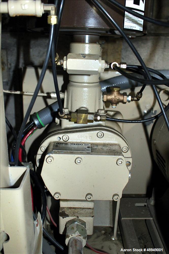 Used Curtis Rotary Screw Air Compressor, 120 Gallon, Model RS25A A-E B101. Rated 104 CFM at 125 psi. Driven by a 25hp,  3/60/200 volt, 1760 rpm motor. Curtis-Toledo compressor model B101-V001. Has mu...