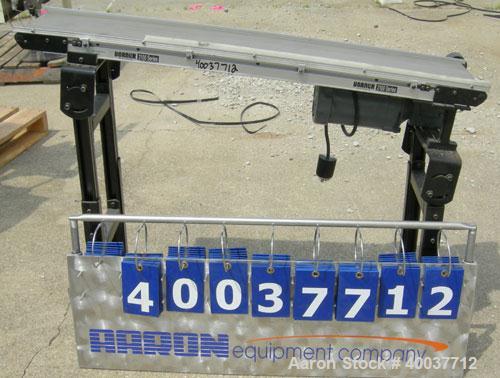 Used Dorner incline belt conveyor, series 2100. Model 2100-1004-05/04. 10" wide x 48" long cloth belt, driven by a 1/2hp, 3/60/208-230/460 volt, 1725 rpm gearmotor, ratio 5 to 1. Mounted on an adjust...