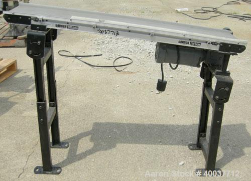 Used Dorner incline belt conveyor, series 2100. Model 2100-1004-05/04. 10" wide x 48" long cloth belt, driven by a 1/2hp, 3/60/208-230/460 volt, 1725 rpm gearmotor, ratio 5 to 1. Mounted on an adjust...