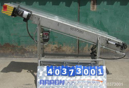Used Sager Incline Belt Conveyor. 12" wide x approximately 80" long belt.  Driven by a 1/2 hp, 3/60/230/460 volt, 1730 rpm motor thru reducer.  Includes an E-trac AC inverter.  Mounted on a stainless...