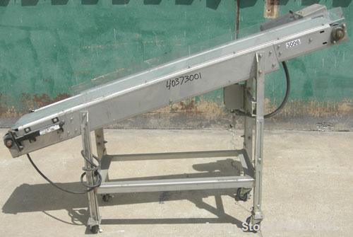 Used Sager Incline Belt Conveyor. 12" wide x approximately 80" long belt.  Driven by a 1/2 hp, 3/60/230/460 volt, 1730 rpm motor thru reducer.  Includes an E-trac AC inverter.  Mounted on a stainless...