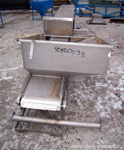 Used Heat and Control Inclined Belt Conveyor. 16" wide x 192" long plastic belt with 2" high pleats. Bottom feed with hopper, end discharge with 2 sided diverter. Driven by a 1 hp, 3/60/575 volt, 172...