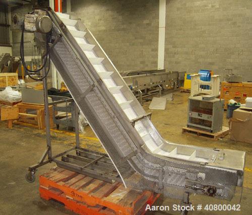 Used Inclined "S" Shaped Conveyor, 304 stainless steel frame. 14" wide x 3" tall cleated plastic belt, 24" long bottom infeed section, 72" long incline section, 12" long top discharge section, approx...