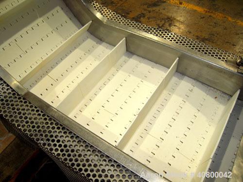 Used Inclined "S" Shaped Conveyor, 304 stainless steel frame. 14" wide x 3" tall cleated plastic belt, 24" long bottom infeed section, 72" long incline section, 12" long top discharge section, approx...