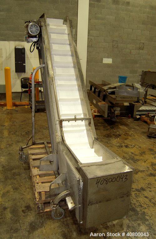 Used Inclined "S" Shaped Conveyor, 304 stainless steel frame. 12" wide x 3" tall cleated plastic belt, 24" long bottom infeed section, 72" long incline section, 12" long top discharge section, approx...
