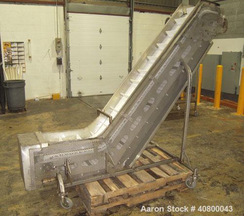 Used Inclined "S" Shaped Conveyor, 304 stainless steel frame. 12" wide x 3" tall cleated plastic belt, 24" long bottom infeed section, 72" long incline section, 12" long top discharge section, approx...