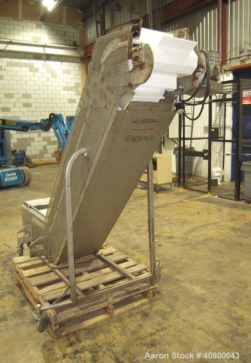 Used Inclined "S" Shaped Conveyor, 304 stainless steel frame. 12" wide x 3" tall cleated plastic belt, 24" long bottom infeed section, 72" long incline section, 12" long top discharge section, approx...