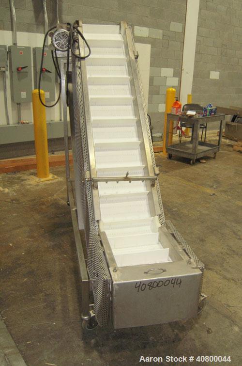 Used Trio-Pac Inclined "S" Shaped Conveyor, 304 stainless steel frame. 14" wide x 3" tall cleated plastic belt, 24" long bottom infeed section, 72" long incline section, 12" long top discharge sectio...