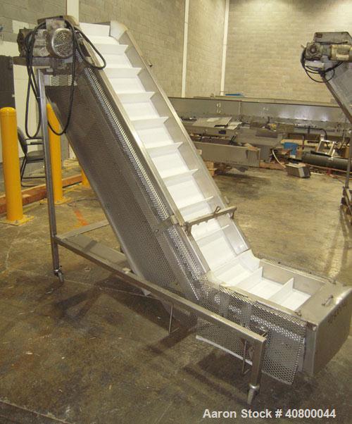 Used Trio-Pac Inclined "S" Shaped Conveyor, 304 stainless steel frame. 14" wide x 3" tall cleated plastic belt, 24" long bottom infeed section, 72" long incline section, 12" long top discharge sectio...
