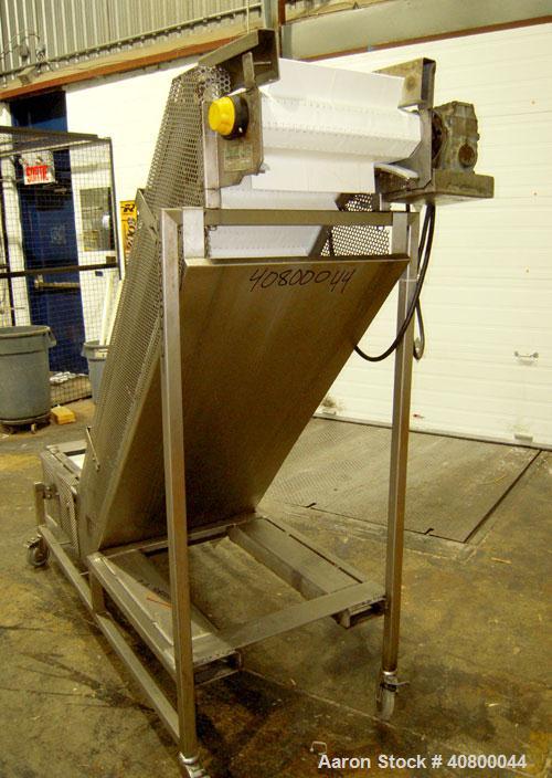 Used Trio-Pac Inclined "S" Shaped Conveyor, 304 stainless steel frame. 14" wide x 3" tall cleated plastic belt, 24" long bottom infeed section, 72" long incline section, 12" long top discharge sectio...
