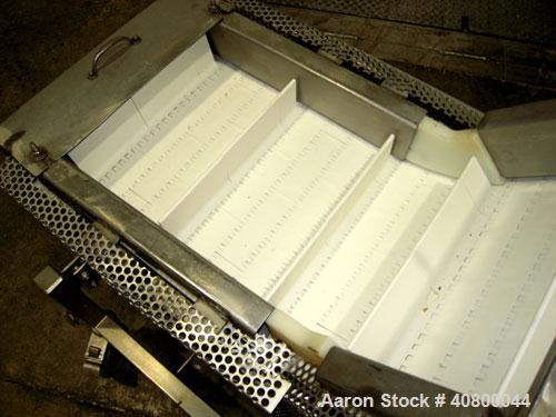 Used Trio-Pac Inclined "S" Shaped Conveyor, 304 stainless steel frame. 14" wide x 3" tall cleated plastic belt, 24" long bottom infeed section, 72" long incline section, 12" long top discharge sectio...