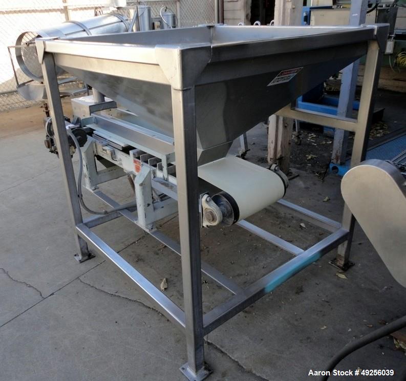 Used Belt infeed conveyor measuring 11" wide x 65" long x 25" high with stainless steel hopper measuring 40" x 40" x 4-1/2" straight side to 19" cone to 8" x 8" discharge. Unit is powered by 1/2 hp, ...