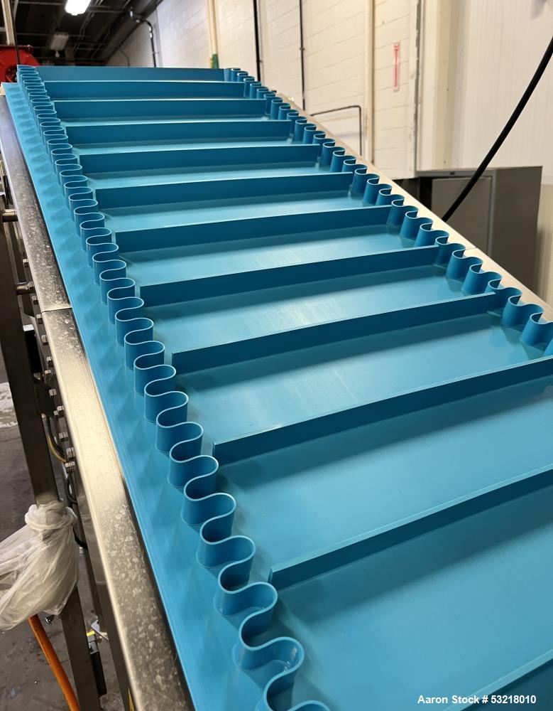 Used Rubber Belt Inclined Conveyor. Pleated belt approximate 23" wide x 13' long x 1-3/4" deep sides x 1-3/4" tall pleats. With VDG drum motor, stainless steel frame