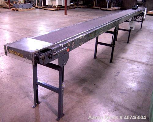 Used Hytrol Belt Conveyor. 13" wide x 296" long rubber belt, driven by a 1/2 hp, 90 volt, 1750 rpm DC gearmotor. Includes a Baldor DC drive. Mounted on a carbon steel frame with adjustable legs.