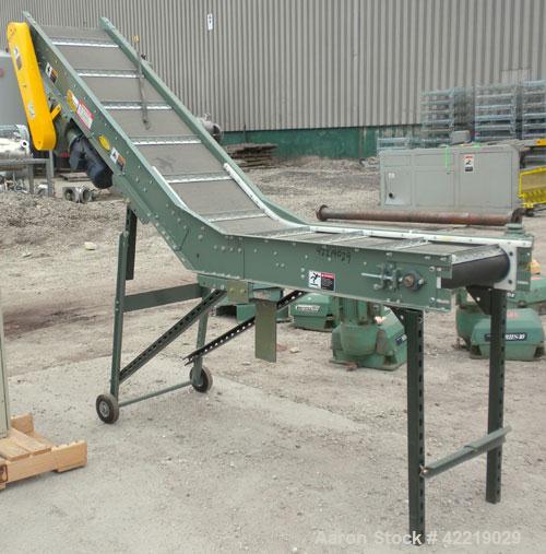 Used Hytrol Inclined Belt Conveyor, carbon steel. 18" wide x 48" long horizontal section x 72" long inclined section. 12" long pockets. 38" Load height, 80" discharge height. Driven by a 1/2 hp, 90 v...