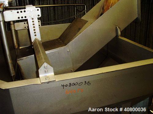 Used Inclined Plastic Belt Conveyor. 18" wide x 96" long with 9" wide x 3" tall off set pockets. 301 stainless steel supply feed hopper, 64" wide x 56" long x approximately 56" deep. Driven by an app...