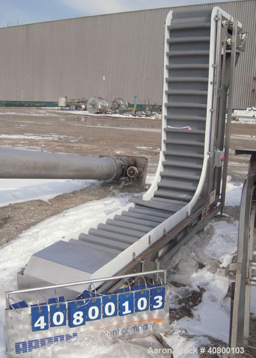 Unused- Key Technology Intralox Belt Conveyor, Model 435561, 304 stainless steel. Plastic belt with 4" flights on 6" centers, 24" wide (21 7/8" wide conveying width) x 84" horizontal bottom section x...