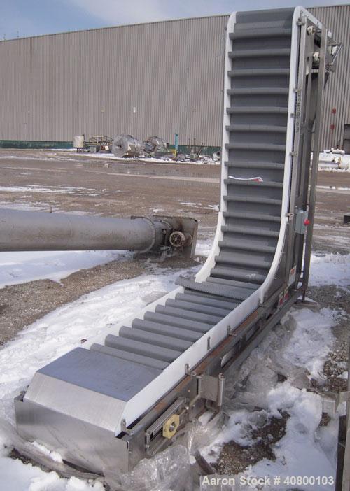 Unused- Key Technology Intralox Belt Conveyor, Model 435561, 304 stainless steel. Plastic belt with 4" flights on 6" centers, 24" wide (21 7/8" wide conveying width) x 84" horizontal bottom section x...