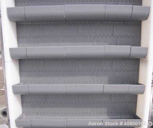 Unused- Key Technology Intralox Belt Conveyor, Model 435561, 304 stainless steel. Plastic belt with 4" flights on 6" centers, 24" wide (21 7/8" wide conveying width) x 84" horizontal bottom section x...