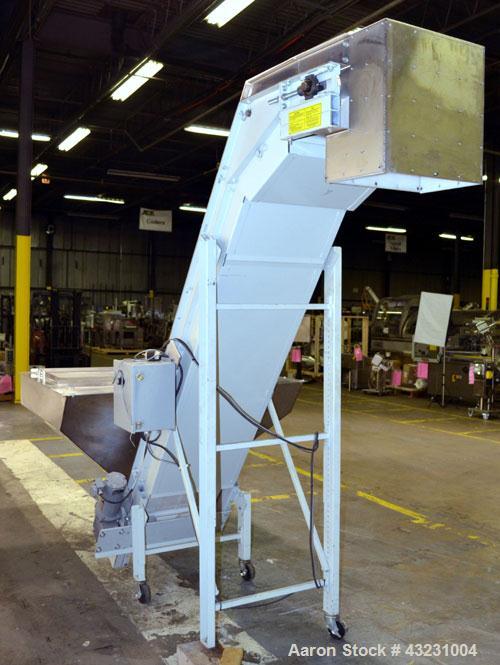 Used Bulk Elevator Feeder, Stainless Steel. Approximate 10" widex 84’’ long pleated belt, approximate 80" discharge height. 56’’ x 42’’ x 24’’ Deep bulk supply hopper. Driven by an approximate 1/2 hp...