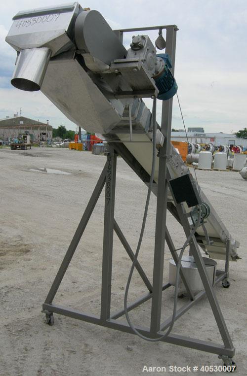 Used Incline Belt Conveyor, 304 stainless steel. 12" wide x 172" long rubber belt, driven by a 1 hp, 3/60/460 volt, 1745 rpm gearmotor, ratio 30 to 1 with a Danfoss VLT 2800 controller. Manually adju...