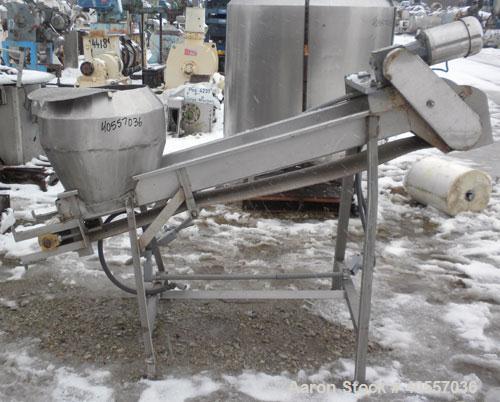 Used Incline Belt Conveyor. 12" wide x 84" long cleated rubber belt. Driven by a 1 hp, 3/60/208-230/460 volt, 1740 rpm gear motor, ratio 50 to 1. Mounted on a stainless steel frame.